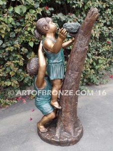 Baby Rescue Bronze Statue of kids playing together rescuing baby birds in tree