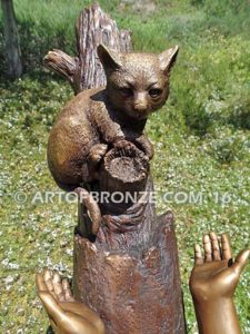 Big Rescue closeup C Bronze statue of boy and girl rescuing with cat in tree