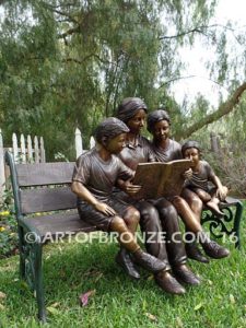 Making a Difference bronze sculpture of four children sitting on bench reading a book