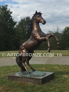 Thunderstorm sculpture of reared horse with forelegs off the ground and hind legs attached bronze base