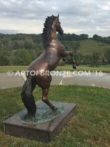 Thunderstorm sculpture of reared horse with forelegs off the ground and hind legs attached bronze base