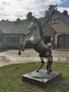 Thunderstorm sculpture of reared horse with forelegs off the ground and hind legs attached bronze base