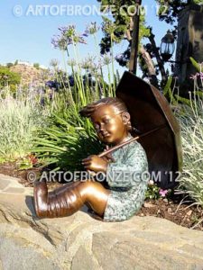 Summer Breeze bronze garden sculpture of cute young girl in the sun with umbrella