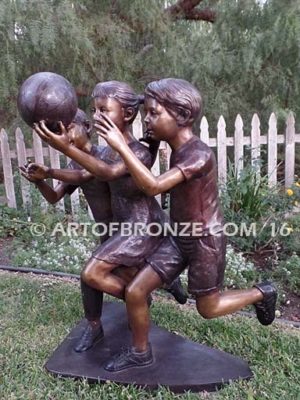 Playing Ball bronze sculpture of girl and two boys juggling ball