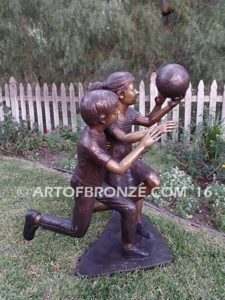 Playing Ball bronze sculpture of girl and two boys juggling ball