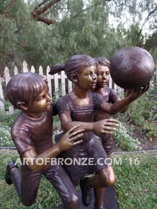 Playing Ball bronze sculpture of girl and two boys juggling ball