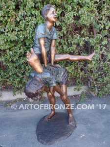 Leapfrog bronze sculpture of two kids playing leapfrog