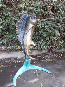 Heroic sculpture of bronze leaping sailfish that can spray water from bill into estate fountain