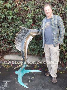 Heroic sculpture of bronze leaping sailfish that can spray water from bill into estate fountain