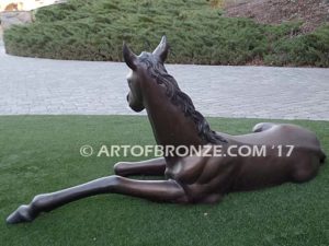 Spring Blessing bronze sculpture of laying foal, filly, colt and yearling horse for ranch or equestrian center