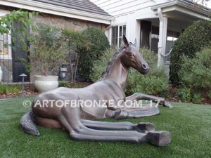 Spring Blessing bronze sculpture of laying foal, filly, colt and yearling horse for ranch or equestrian center