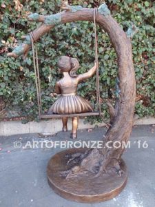 The Swing sculpture of pretty princess girl wearing dress on swing