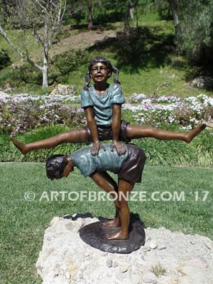 Leapfrog bronze sculpture of two kids playing leapfrog