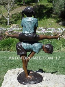 Leapfrog bronze sculpture of two kids playing leapfrog