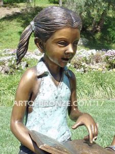 Favorite Teacher bronze sculpture of older girl reading book to younger boy