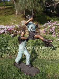 Push Me Higher bronze sculpture for park or playground of boy pushing girl on swing