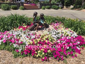 Favorite Teacher bronze sculpture of older girl reading book to younger boy