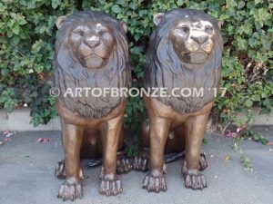 Beauty & Strength high quality cast bronze African lion pair sitting next to each other
