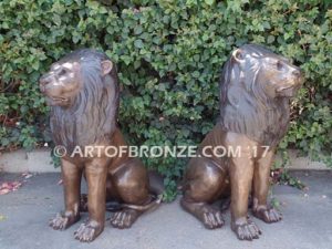 Beauty & Strength high quality cast bronze African lion pair sitting next to each other