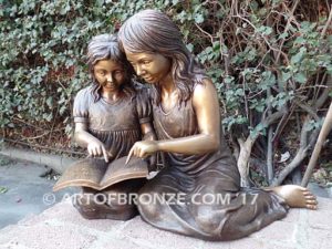 Together Forever bronze sculpture of older girl tutoring younger girl with book