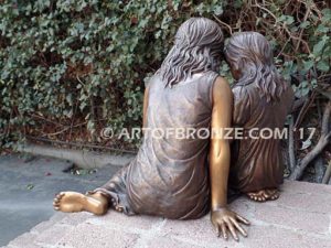 Together Forever bronze sculpture of older girl tutoring younger girl with book