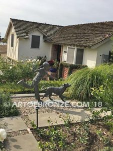 Friends for Life bronze sculpture of girl playing and running with her pet dog