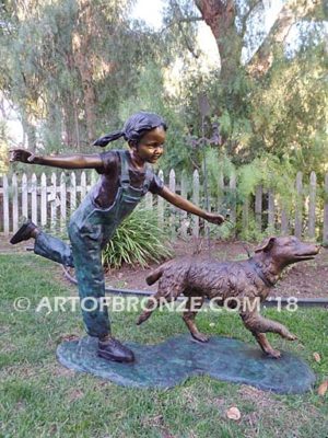 Friends for Life bronze sculpture of girl playing and running with her pet dog