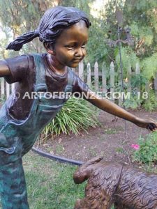 Friends for Life bronze sculpture of girl playing and running with her pet dog