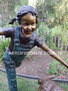 Friends for Life bronze sculpture of girl playing and running with her pet dog