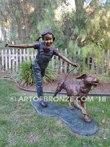 Friends for Life bronze sculpture of girl playing and running with her pet dog