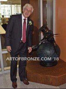 Global Scholar bronze sculpture of boy sitting on globe wearing graduation cap and reading book