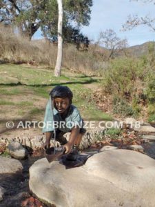 Junior Sailor bronze sculpture of young boy with sailboat in his hands