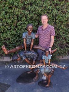 Leapfrog bronze sculpture of two kids playing leapfrog