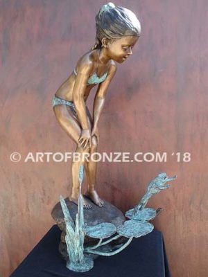 Pond Fun bronze sculpture of young girl in bathing suit playing with bullfrog