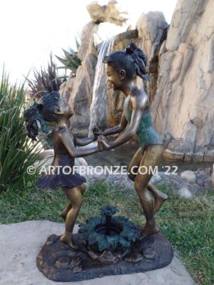 Dance Around bronze statue of girls in bathing suits dancing and jumping