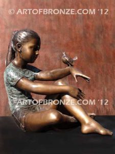 Garden Help bronze sculpture of girl sitting with crossed legs and bird on her hand