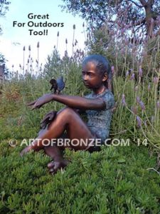 Garden Help bronze sculpture of girl sitting with crossed legs and bird on her hand