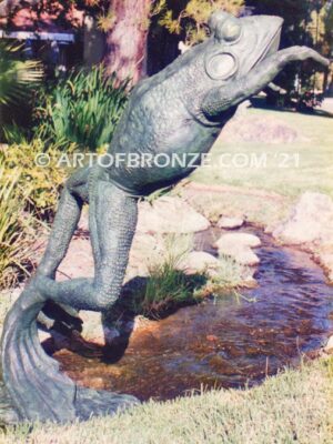 King of the Pond giant frog jumping statue monument with big, webbed toes and eyes