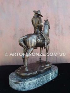 On the Range bronze sculpture of western cowboy on cattle horse