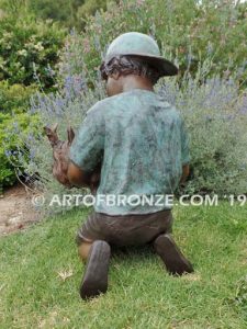 Play Pal bronze sculpture of young boy holding his dog