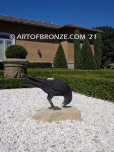 Raven bronze sculpture of standing ravens playing around fountain