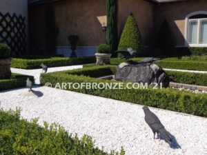 Raven bronze sculpture of standing ravens playing around fountain