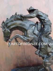 Bronco Buster bronze sculpture after Frederic Remington of cowboy ranger on horse in white house