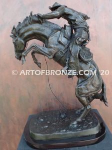 Bronco Buster bronze sculpture after Frederic Remington of cowboy ranger on horse in white house