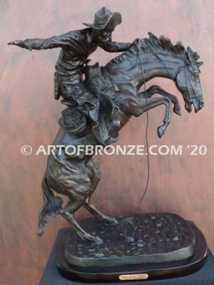 Bronco Buster bronze sculpture after Frederic Remington of cowboy ranger on horse in white house