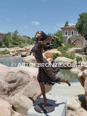 Wind Swept bronze statue joyous woman gracefully balancing on one foot