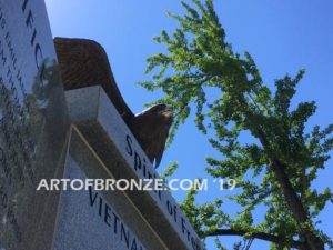 Vietnam War Memorial outdoor monumental statue of an eagle landing atop granite pillar