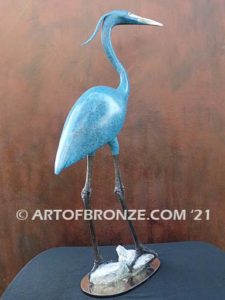 Heron in Everglades sculpture heron standing on rocks by British artist Brian Arthur