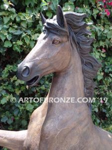 Thunderstorm sculpture of reared horse with forelegs off the ground and hind legs attached bronze base