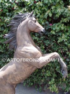 Thunderstorm sculpture of reared horse with forelegs off the ground and hind legs attached bronze base